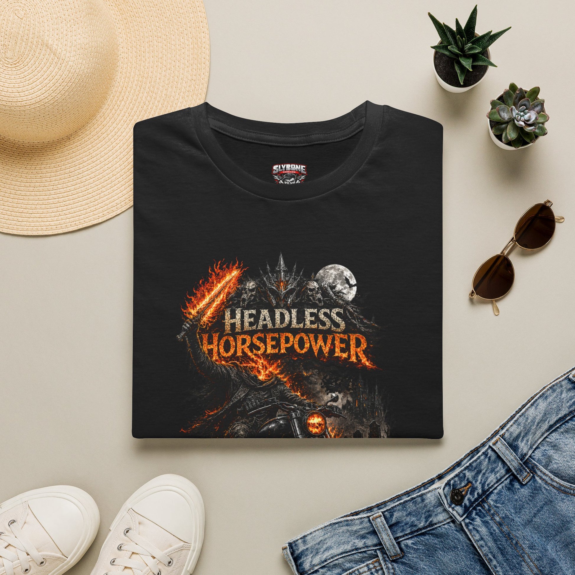 Headless Horsepower Halloween motorcycle graphic featuring a headless rider on a black muscle bike surrounded by flames and haunted scenery.