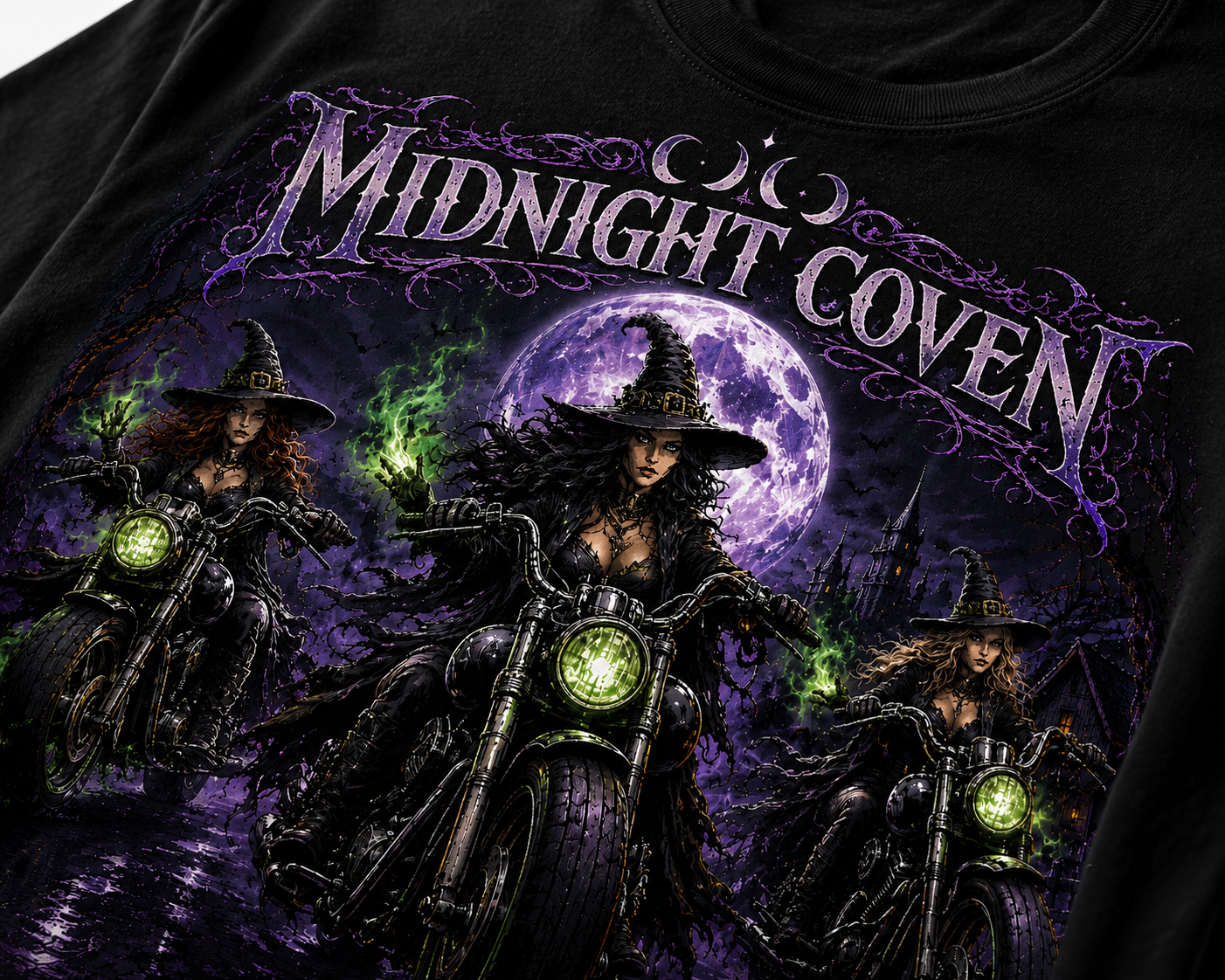 Three witches riding vintage motorcycles beneath a glowing purple moon with green witchfire in a haunted forest, featured on a premium Slybone Threads graphic T-shirt.